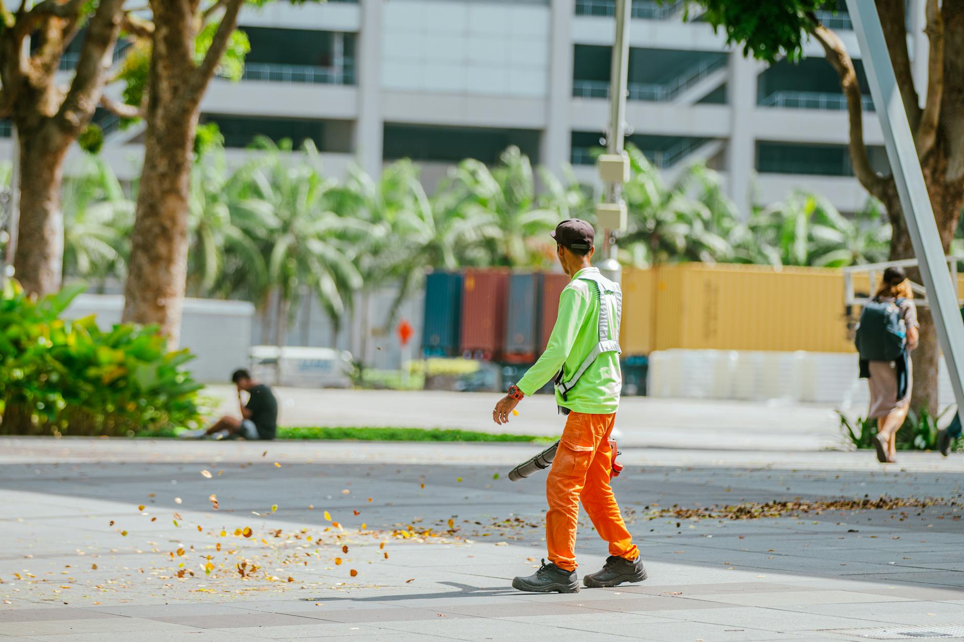 A clean, organized tree service work site in a Bel Air neighborhood, showing safety cones and a wood chipper.
